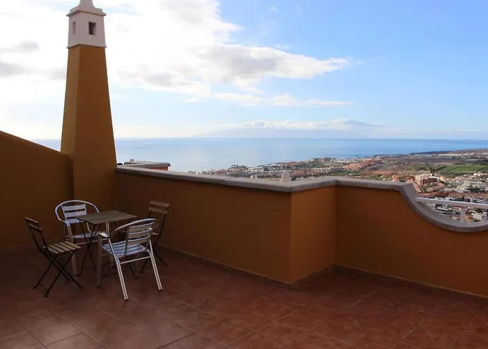 With A Serene Ocean And Mountain View *