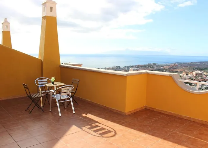 With A Serene Ocean And Mountain View *